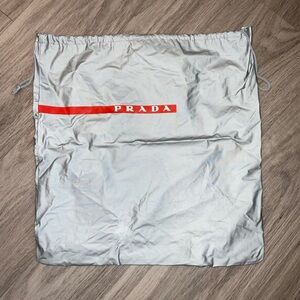 Prada Metallic Silver Dust Bag with Red Logo